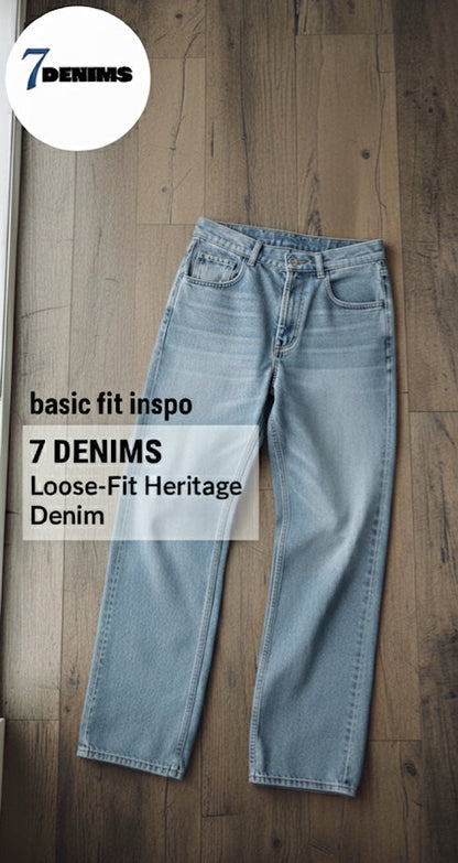 Pair of loose-fit heritage denim jeans on a wooden floor with '7 Denims' branding.
